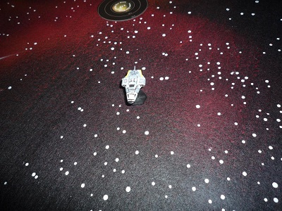 A Beowulf-class Free Trader sits alone on a starfield battlemat
